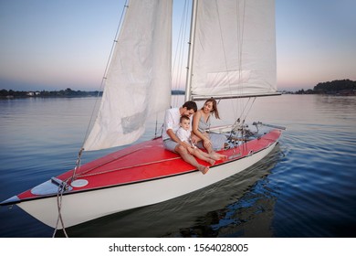 Happy family with adorable son resting on a yacht - Powered by Shutterstock