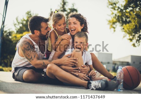 Happy family after basketball game. Children with parents have fun. 