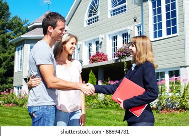 Happy Family With Agent Realtor Near New House.