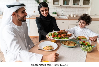 happy family from arab united emirates eating together and celebrating the national day holidays