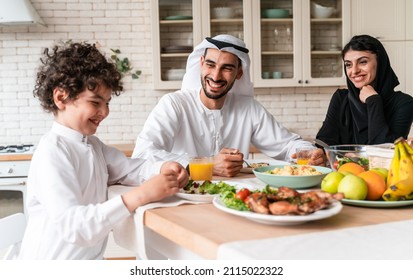 happy family from arab united emirates eating together and celebrating the national day holidays - Shutterstock ID 2115022322