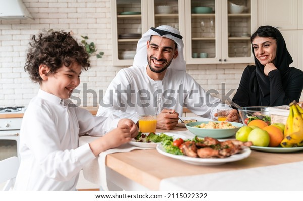 happy family from arab united\
emirates eating together and celebrating the national day\
holidays