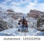 Happy family with arms around each other enjoying beautiful  mountain view on winter  hiking trip. Glenwood Springs, Colorado, USA.