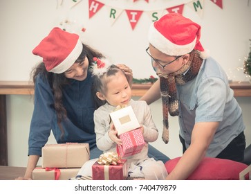 Happy Family Asia Family Wear Santa Claus Hat Unwrap Christmas Gift Box At House Xmas Party,Holiday Celebrating Festive Concept,vintage Filter