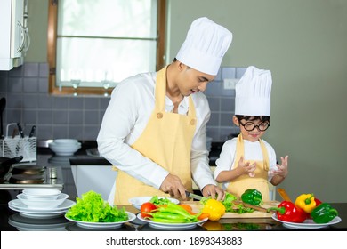 Happy Family Asian Man Young Father With Son Boy Cooking Healthy Salad For The First Time. First Lesson And Healthy Lifestyle Concept.