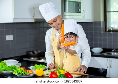 Happy Family Asian Man Young Father With Son Boy Cooking Healthy Salad For The First Time. First Lesson And Healthy Lifestyle Concept.