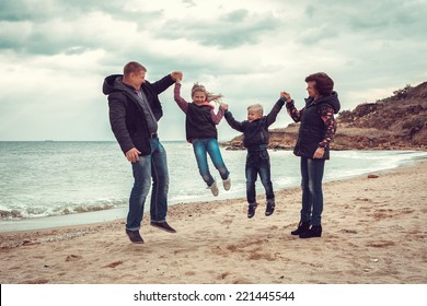 Happy Family Autumn At Beach 