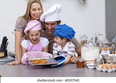 Happy Family Baking Cookies Together In The Kitchen