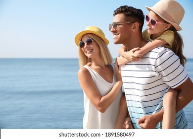 Happy family at beach on sunny summer day