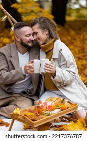 Happy Family, Beautiful Couple On A Fall Picnic In The Park, Surprise Date. Cozy Autumn Vibes. Spending Quality Time Together, Having Fun