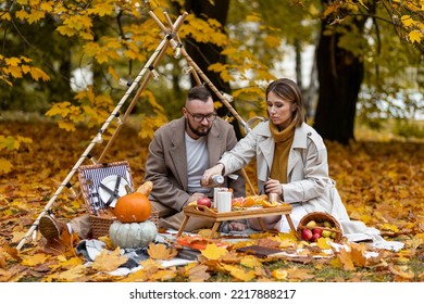 Happy Family, Beautiful Couple On A Fall Picnic In The Park, Surprise Date. Cozy Autumn Vibes. Spending Quality Time Together, Having Fun