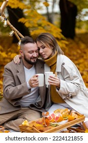 Happy Family, Beautiful Couple On A Fall Picnic In The Park, Surprise Date. Cozy Autumn Vibes. Spending Quality Time Together, Having Fun