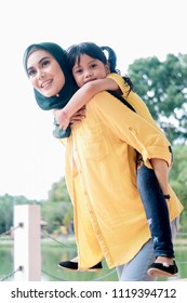 Happy Family, Beautiful Hijab Malaysian/asian Mother And Her Cute Girl Spend Time Together Outdoor. Relationship Of Mother And Daughter Concept. Family Concept.