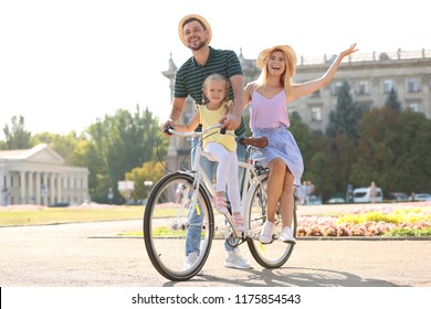 Happy Family With Bicycle Outdoors On Summer Day