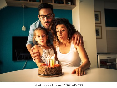 Happy Family Blowing Birthday Candles.Celebration Concept