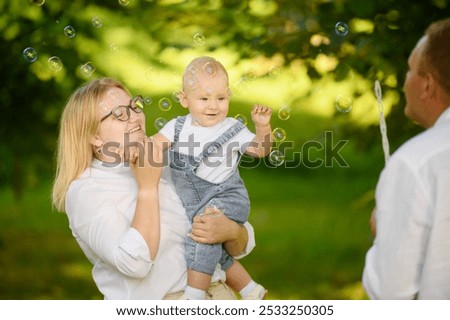 Mother playing with her daughter on the grass