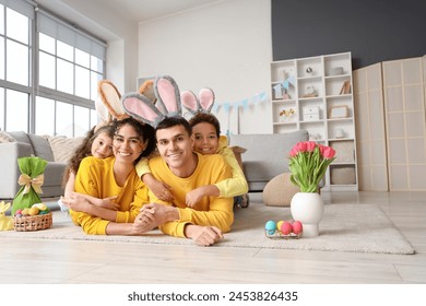 Happy family in bunny ears hugging at home on Easter Day - Powered by Shutterstock