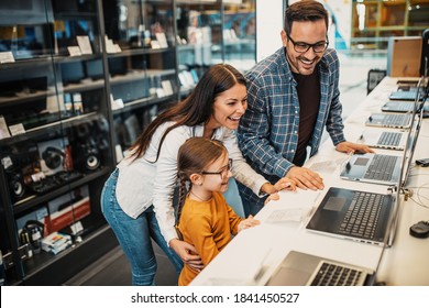 Happy Family Buying Laptop In Store.