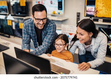 Happy Family Buying Laptop In Store.