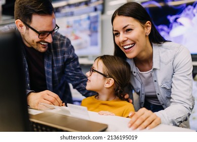 Happy Family Buying Laptop In Store.