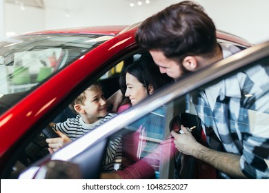 Happy Family Buying A New Car At The Car Showroom.