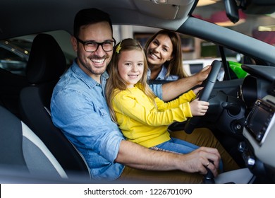 Happy Family Buying A New Car At The Car Showroom.