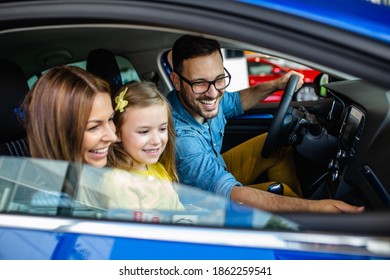 Happy Family Buying A New Car At The Car Showroom.