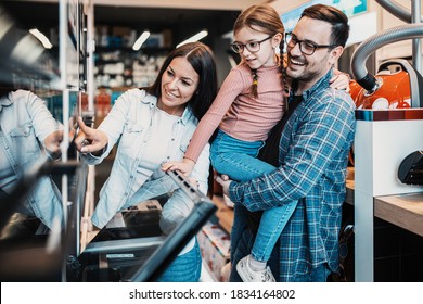 Happy Family Buying Oven In Store.