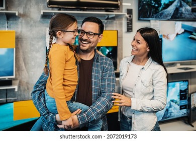 Happy Family Buying TV In Store.