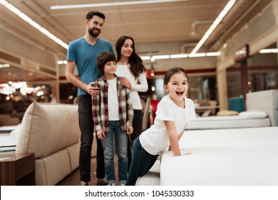 Happy Family Buys New Orthopedic Mattress In Furniture Store. Blissful Choosing Choosing Mattresses In Store. Orthopedic Mattress, For Comfortable Sleep And Healthy Posture.