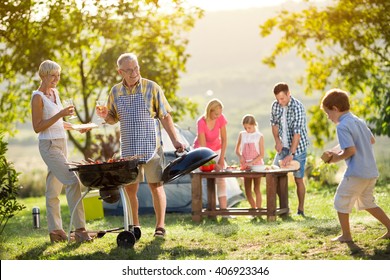 Happy Family Camping And Cooking Bbq
