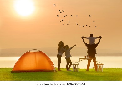 Happy Family Camping Tent Near The Lake With Sunset Or Sunrise Background,happy Family Concept