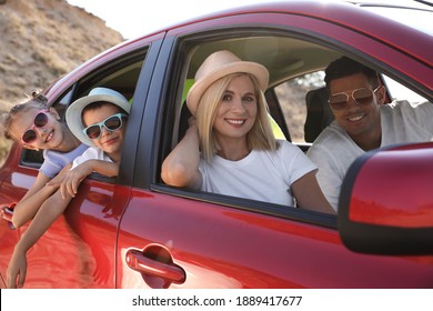 Happy Family In Car At Beach On Sunny Day