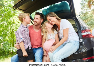 Happy family in the car on summer vacation before leaving for the holidays