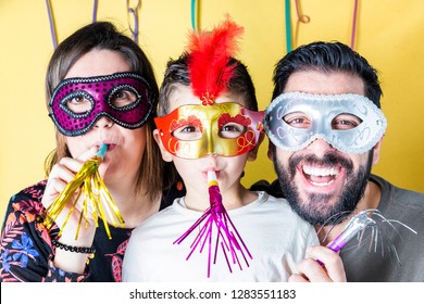 Happy Family In Carnival With Masks With Yellow Background