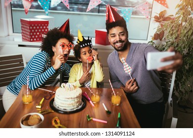 Happy family celebrating a birthday together at home make selfie - Powered by Shutterstock