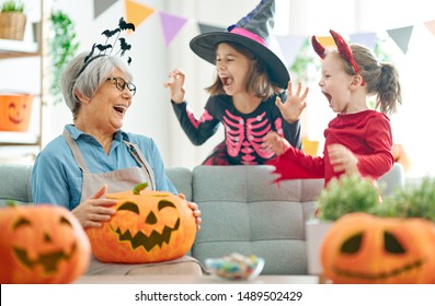 Happy Family Celebrating Halloween. Grandmother And Children At Home.