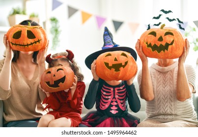 Happy family celebrating Halloween. Grandmother, mother and children at home.                                - Shutterstock ID 1495964462