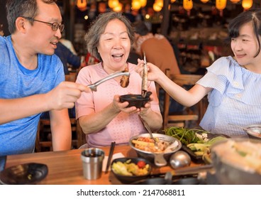 Happy Family Celebrating Mothers Day At Restaurant