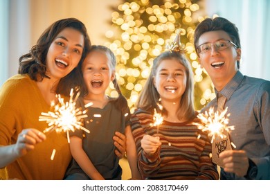 Happy Family Celebrating New Year At Home. Mother, Father And Children.