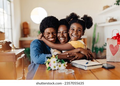 Happy family celebrating together at home. Kids give their mom a bouquet of flowers, bringing joy and love. Special moment showing the beauty of motherhood and the happiness found in simple gestures.