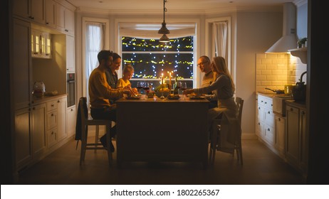 Happy Family Celebrating together, Sitting at the Table Eating Delicious Dinner Meal. Little Child, Young Husband, Wife, Grandfather and Grandmother, Telling Stories, Joking, Having Fun, Being Joyful