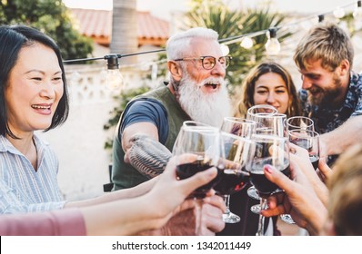 Happy family cheering and toasting with red wine glasses at dinner outdoor - People with different ages and ethnicity  having fun at bbq party - food and drink, retired and young people concept  - Powered by Shutterstock