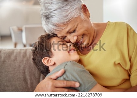 Happy family, child and grandma hug and bond in living room together, happy and content in their home. Relax, smile and love of boy hugging senior woman showing love and having fun in brazil house