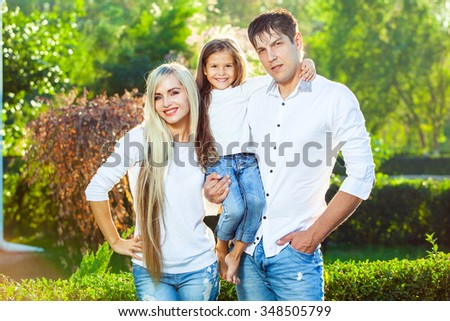 Happy family with child outdoors. in jeans