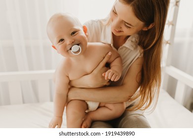 Happy family, child and parenting concept, happy smiling young mom hugs her little child at home, Mothers Day