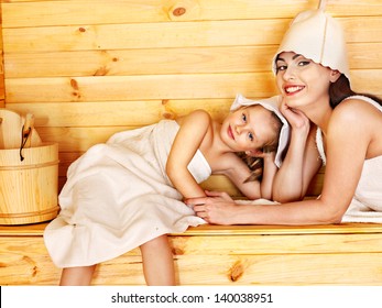 Happy Family With Child Relaxing At Sauna.