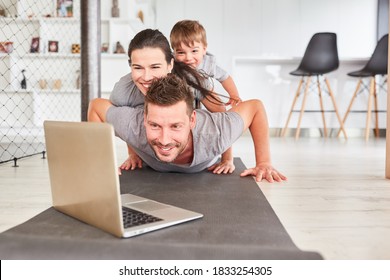 Happy Family With Child Video Chat Online At Home On Laptop Computer