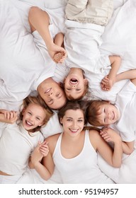 Happy Family With Children In Bed