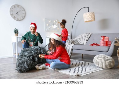 Happy Family With Children Decorating Christmas Tree At Home